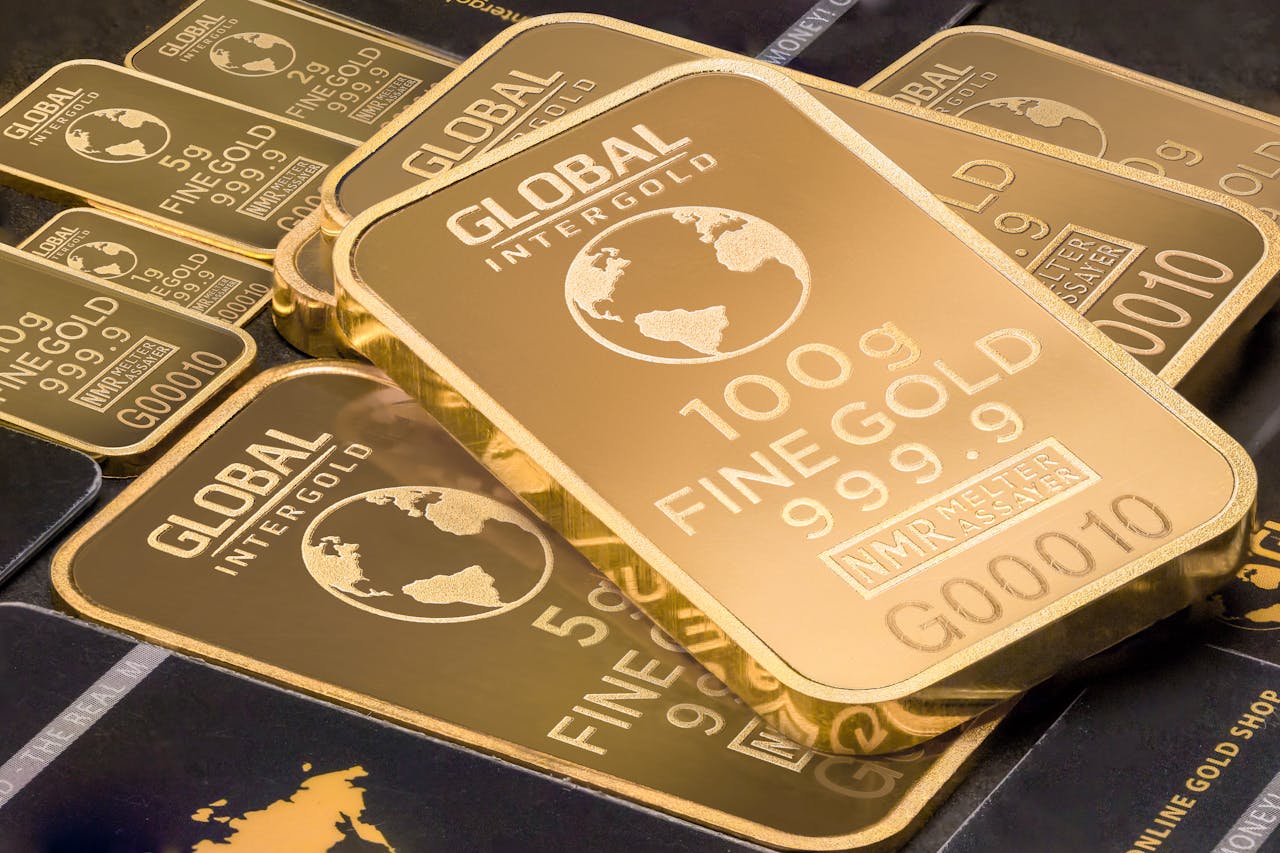 About A detailed shot of gold bars labeled 'Global Intergold' as a symbol of wealth and investment.